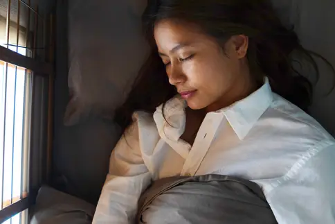 photo of woman sleeping in bed