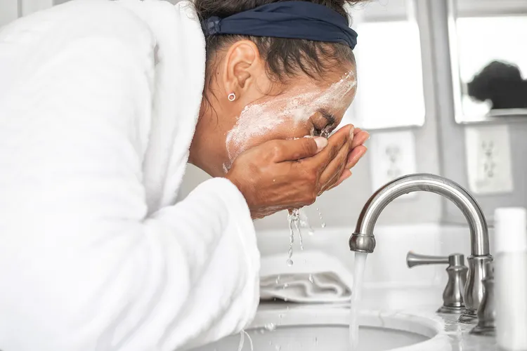 photo of woman removing makeup