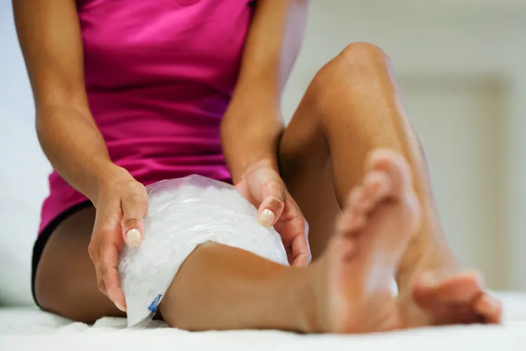 photo of Woman icing knee
