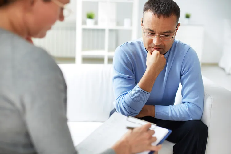 photo of man talking with therapist