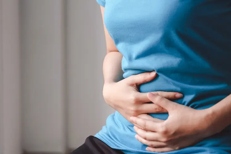 photo of hands holding upset stomach