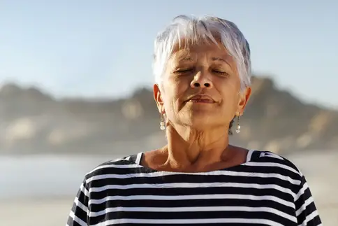 photo of woman breathing deeply outdoors