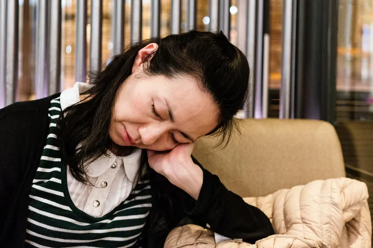 photo of exhausted woman in cafe