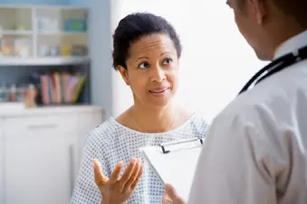 photo of woman talking to doctor