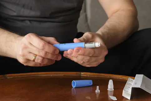 photo of man prepping glp1 inhibitor