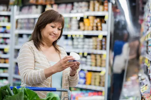 photo of woman reading food label