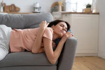 photo of woman taking afternoon nap on sofa,