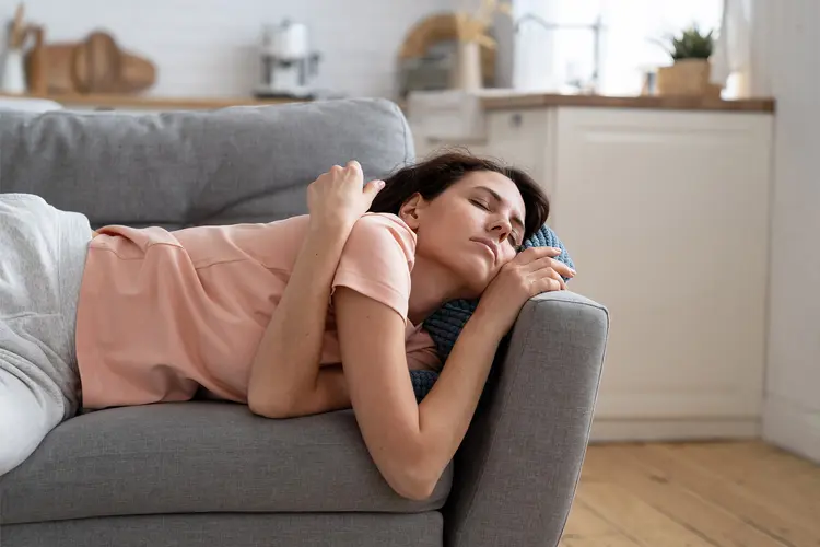 photo of woman taking afternoon nap on sofa,