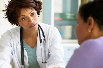 photo of doctor talking with female patient