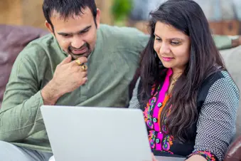 photo of couple doing research on laptop