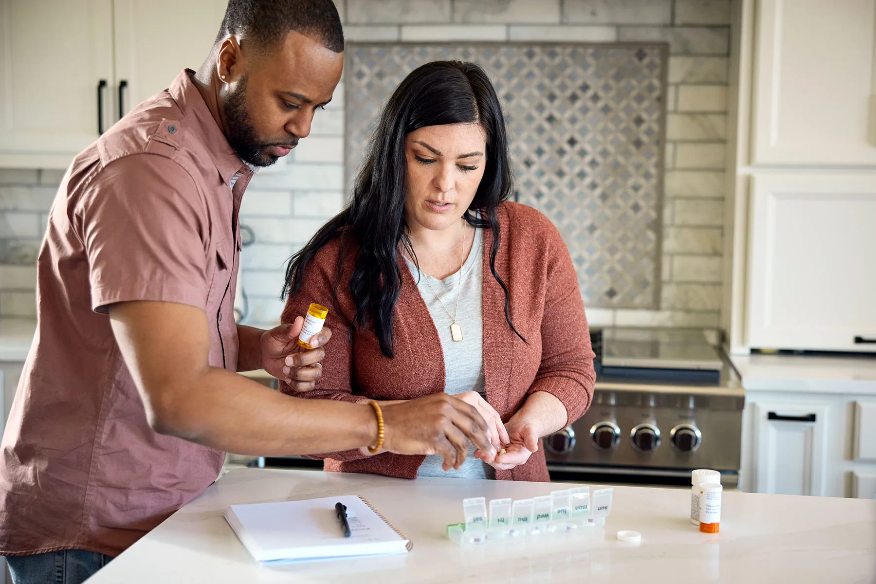 photo of couple putting medications in pill organizer