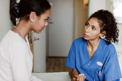 photo of nurse talking with patient