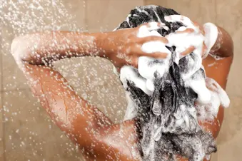 photo of woman shampooing hair 