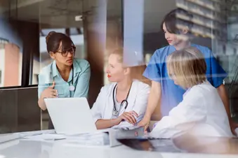 photo of medical care team discussing case