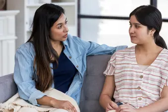photo of mother having serious talk with daughter