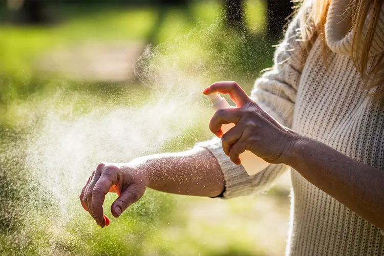 photo of Applying mosquito repellent