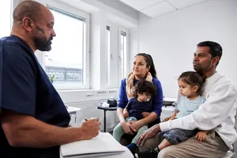 photo of doctor explaining procedure to parents