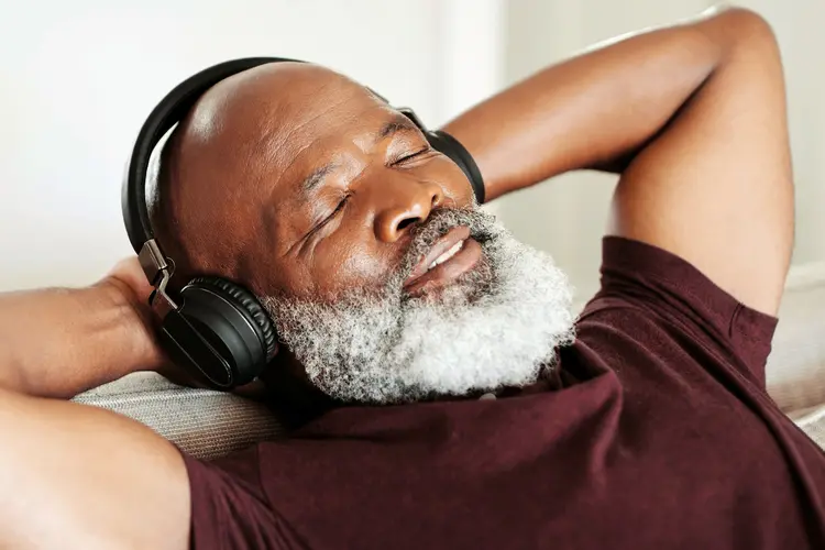 photo of listening to music with headphones