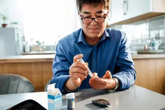 photo of checking blood sugar at kitchen table