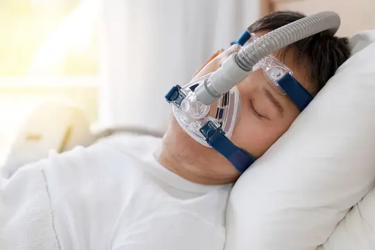 photo of man wearing sleep apnea mask