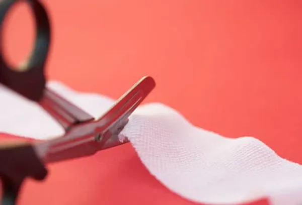 Scissors cutting gauze