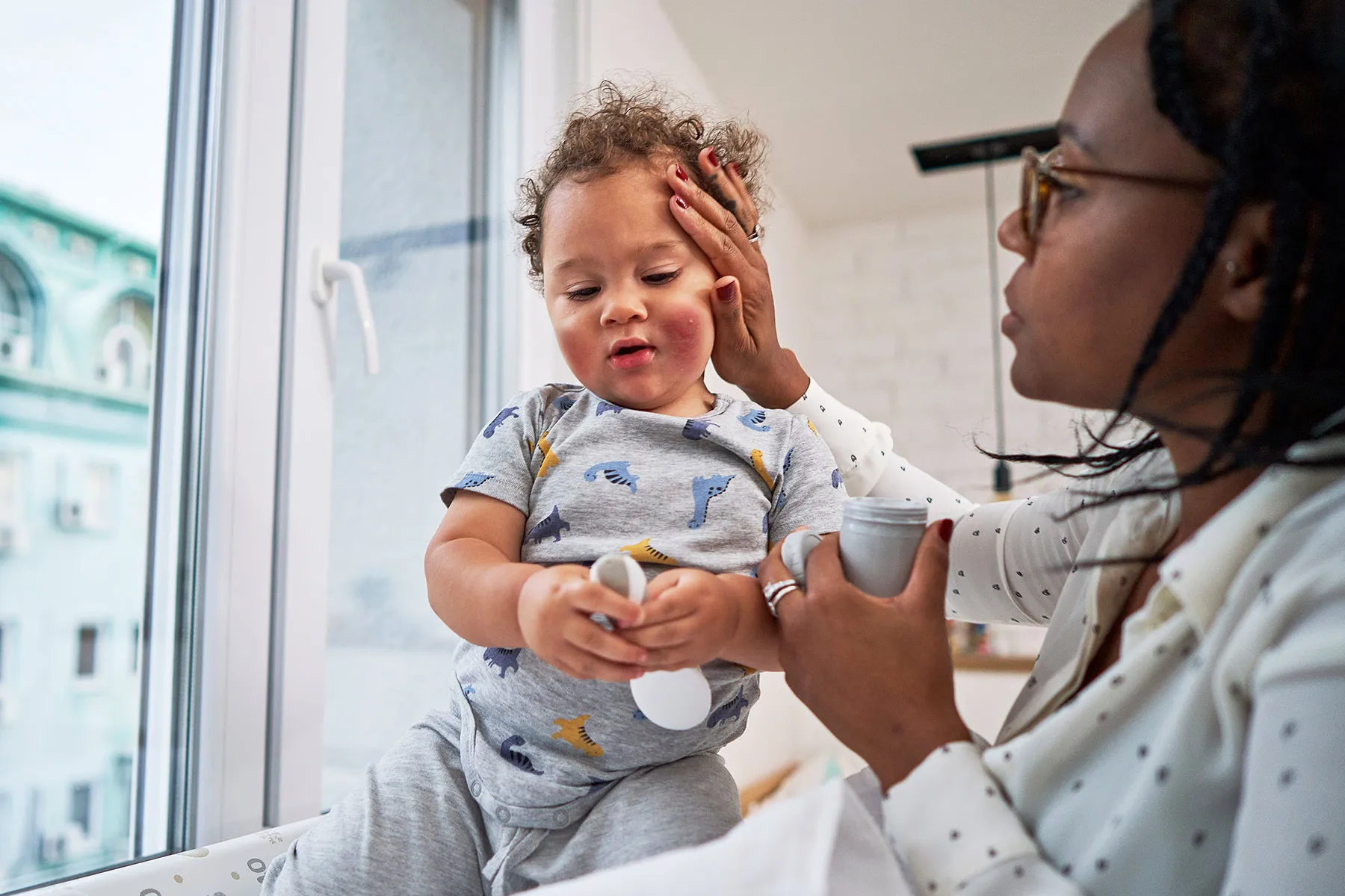 photo of doctor examining toddler with eczema