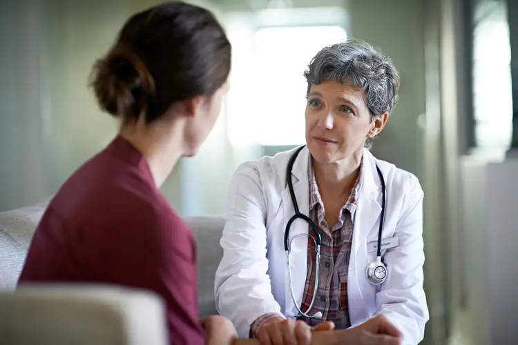 photo of doctor listening to patient
