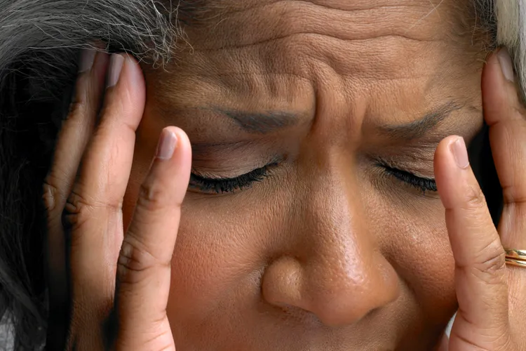 photo of senior woman with headache close up