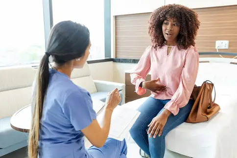 photo of patient describing stomach pain to doctor