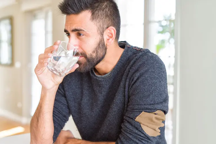 man drinking glass of water