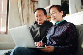 photo of senior couple using laptop
