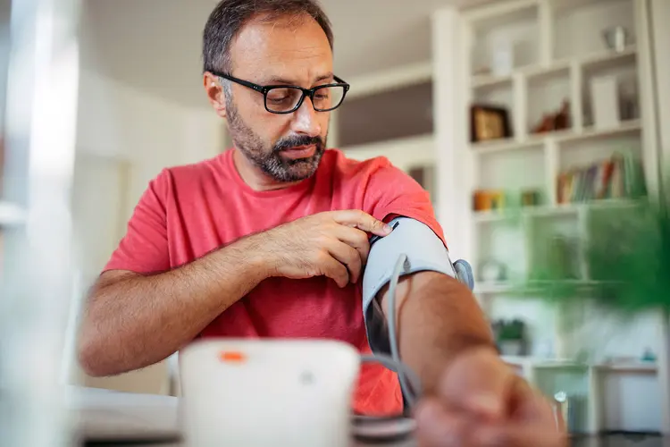 photo of mature man checking blood pressur