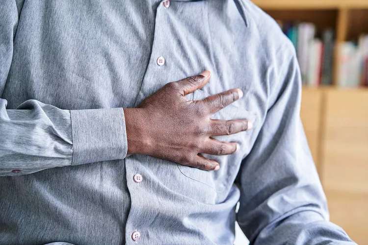photo of man clutching chest