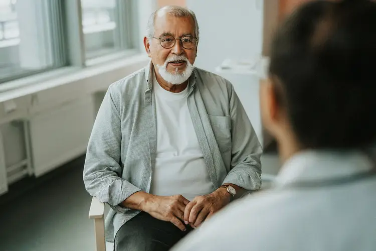 photo of older man talking with doctor