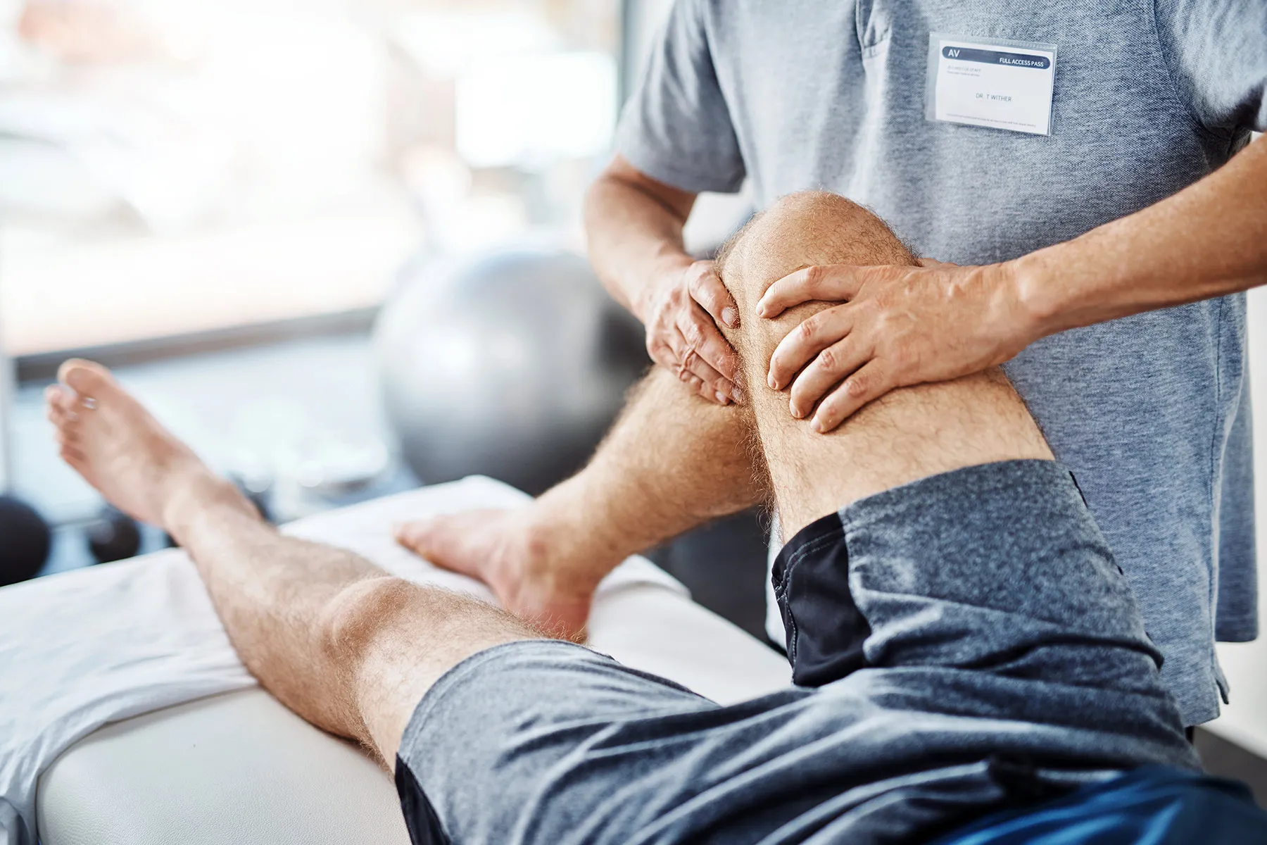 photo of physical therapist working with patient's