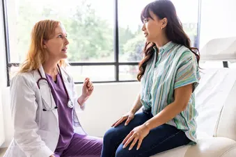 photo of doctor talking to patient