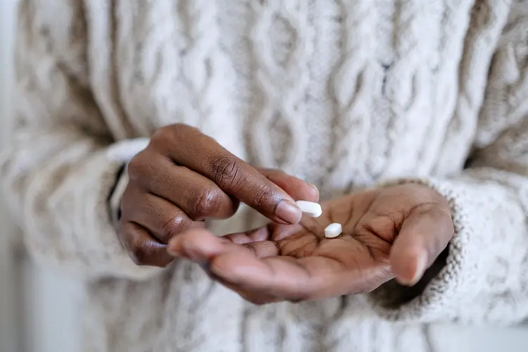 photo of a woman holding pills